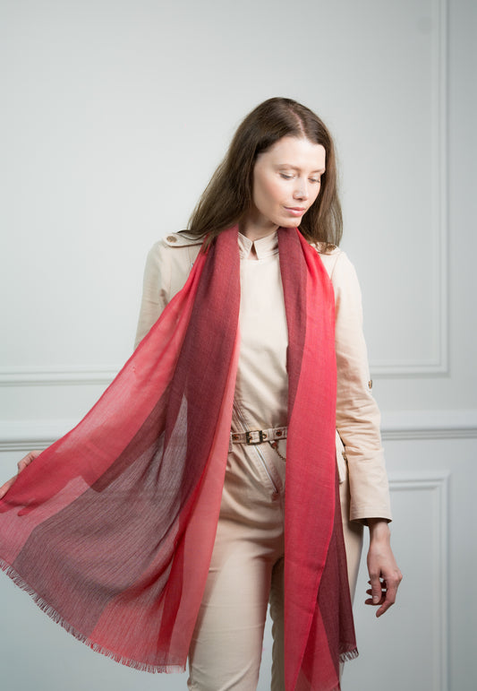 Model wearing Caprus Cashmere's pure cashmere Herringbone Ruby Four Color Block Scarf, featuring ruby red, gray, beige, and white blocks.
