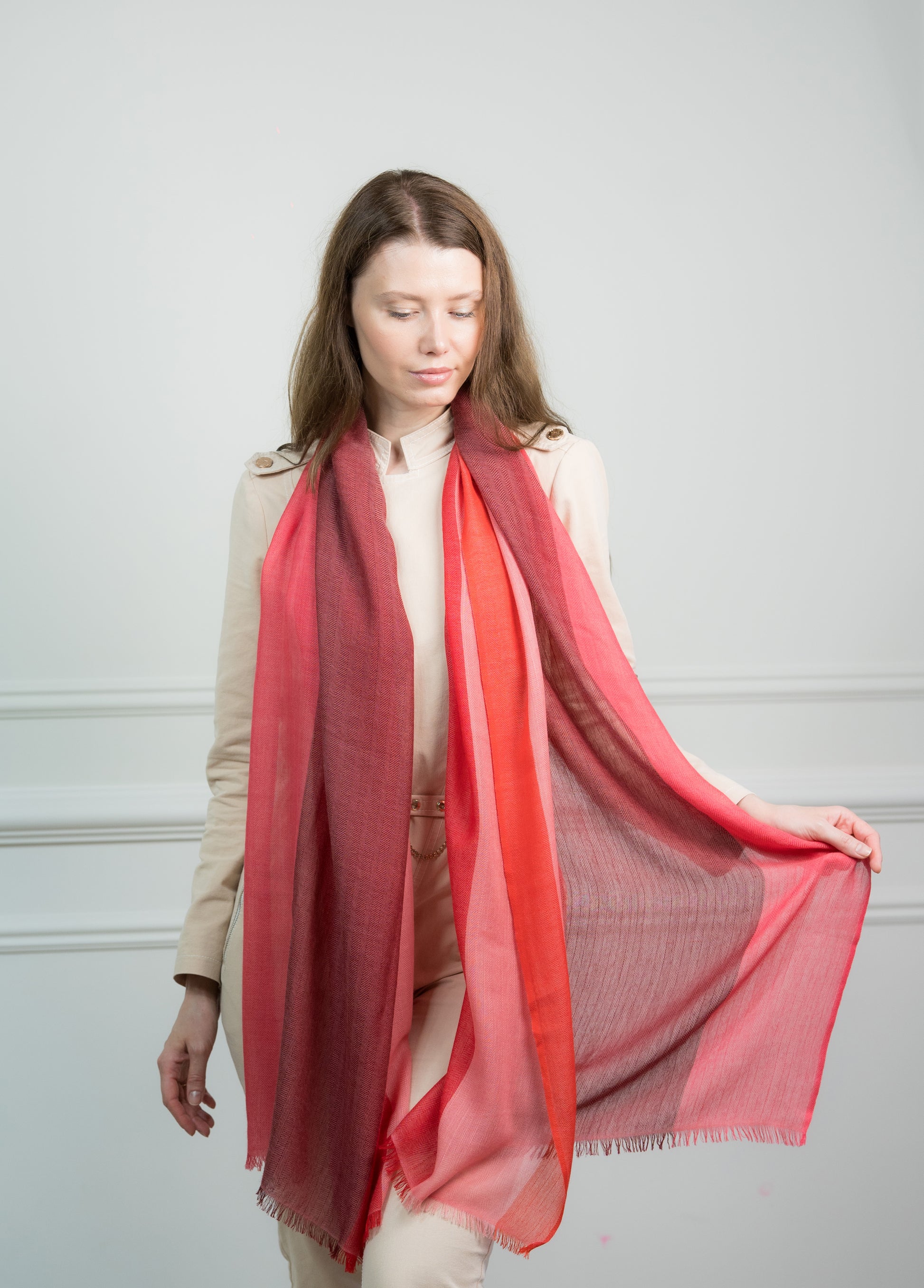 Model draping the Herringbone Ruby Four Color Block Scarf over shoulders, showcasing its versatility as a women's scarf and travel wrap.
