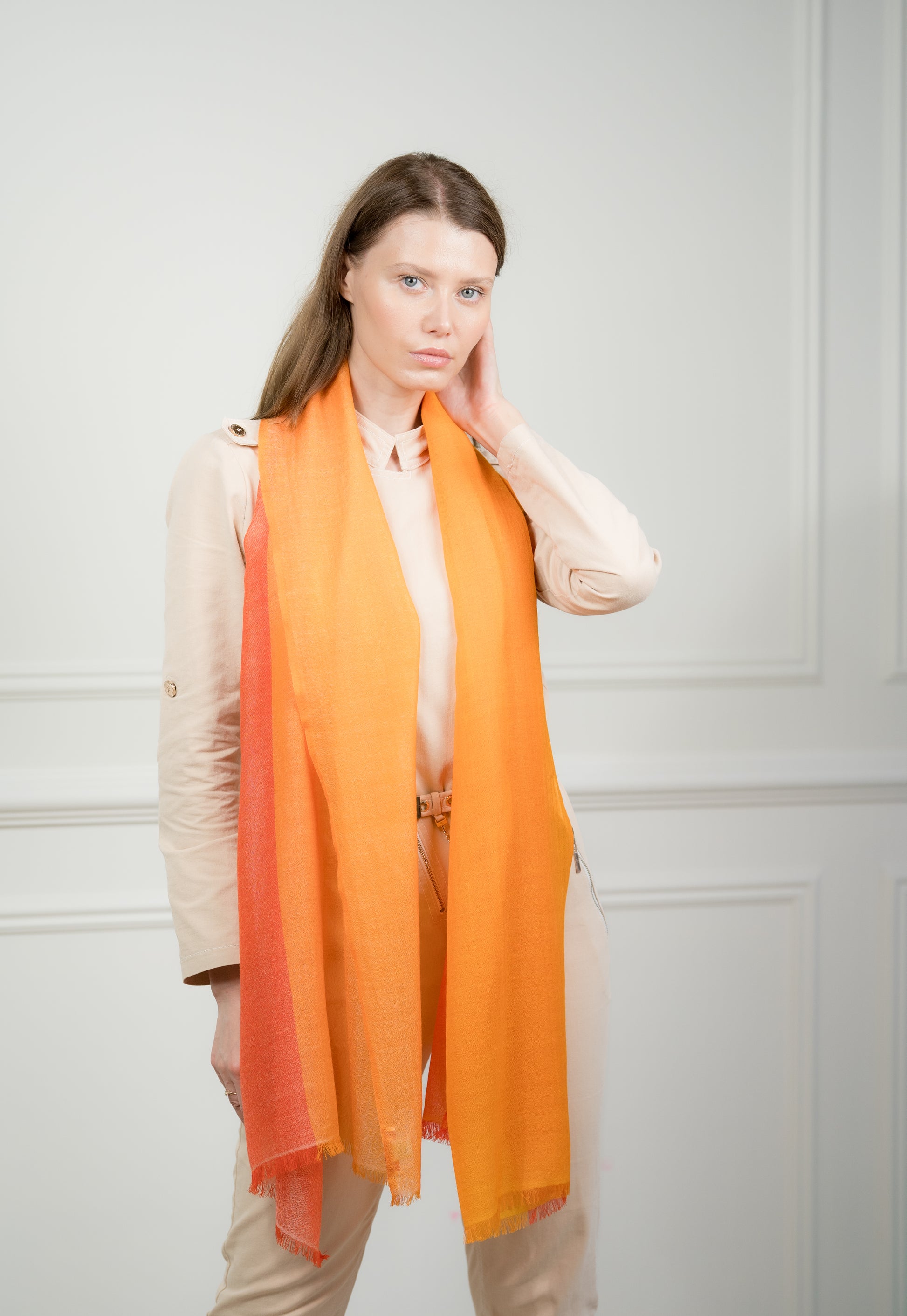 Close-up of the 4 Color Block Tangerine Scarf on a model, highlighting the soft wool texture and transition between tangerine orange and gray blocks.