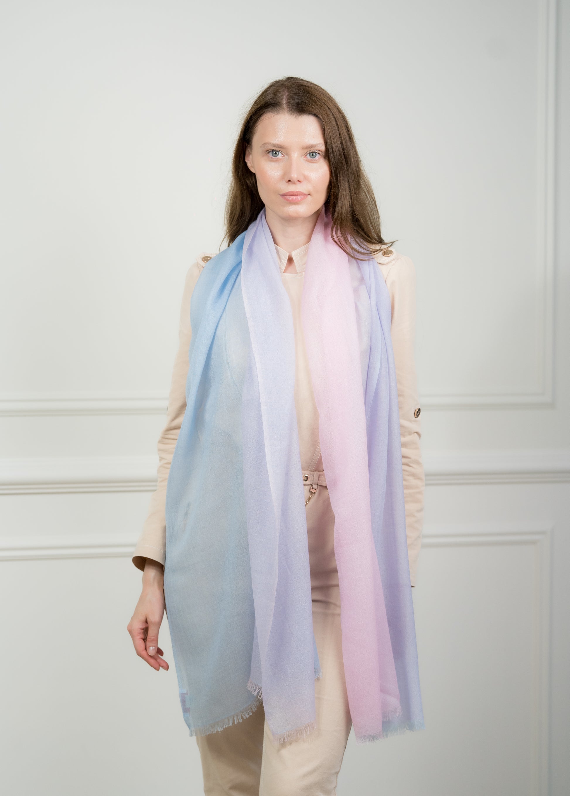 Pure wool scarf with four color blocks—azure, teal, beige, and gray—featuring fringed edges, styled over a neutral outfit.