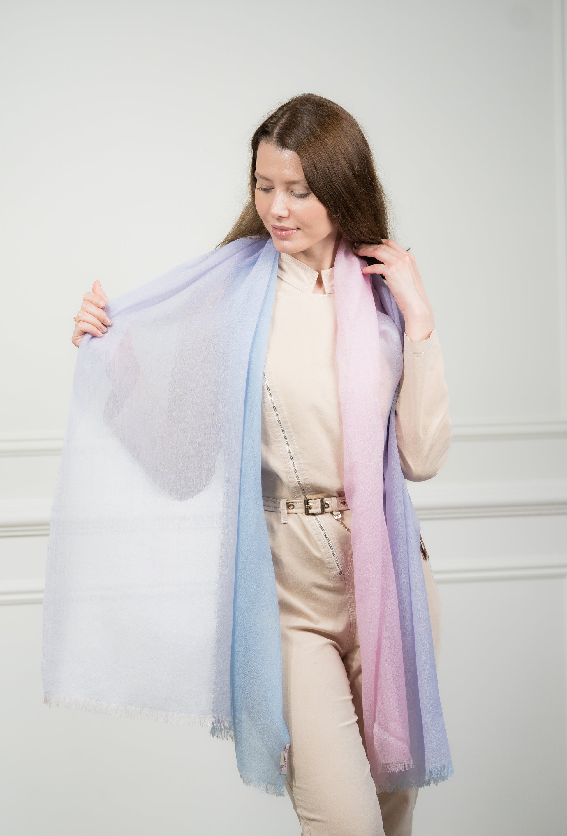 Close-up of the scarf's fringed edges, highlighting the transition between the azure and teal color blocks.