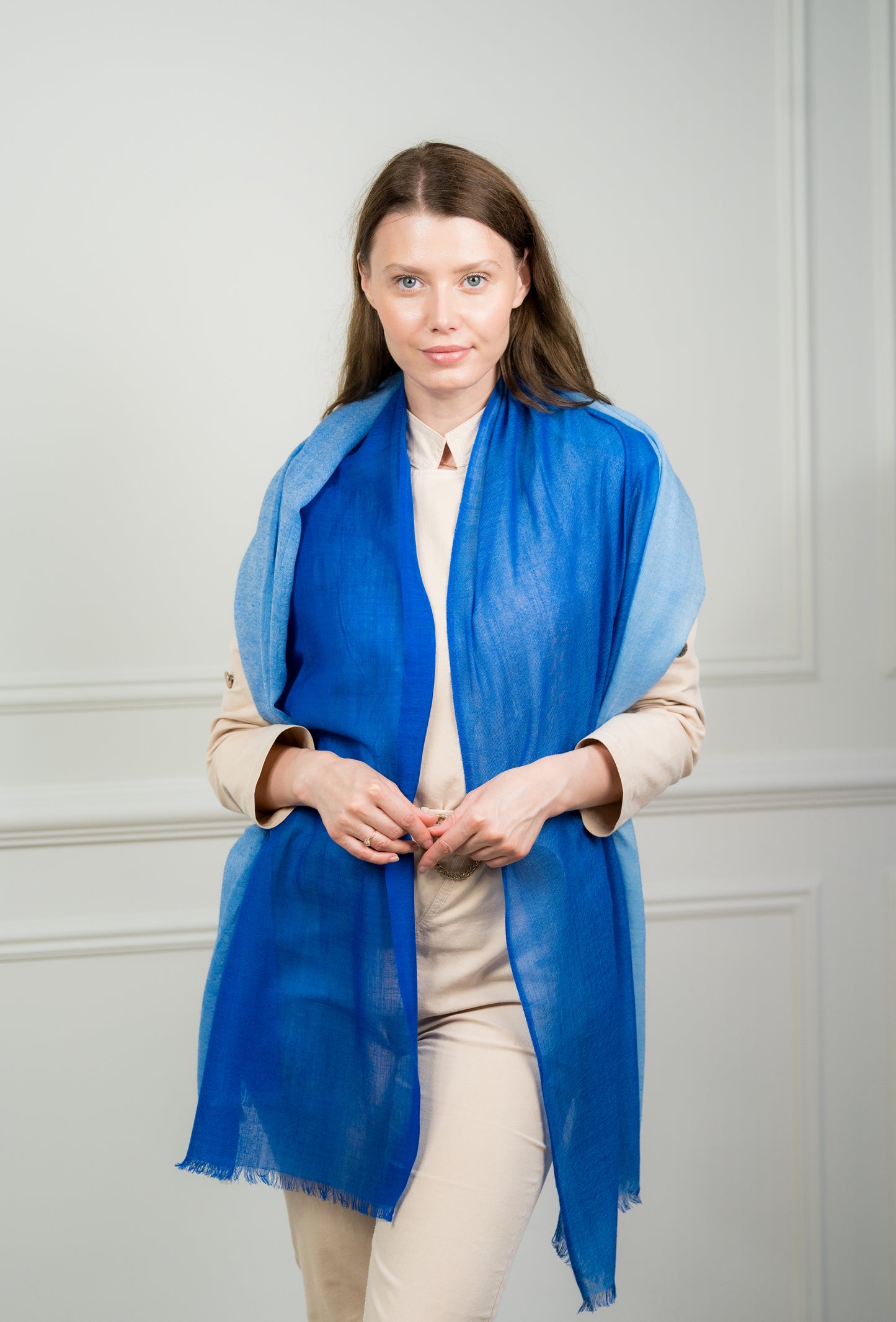 Model wearing Caprus Cashmere's pure wool 4 Color Block Cobalt Scarf, showcasing vibrant cobalt blue, gray, beige, and white color blocks.