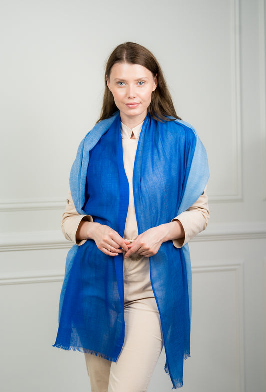 Model wearing Caprus Cashmere's pure wool 4 Color Block Cobalt Scarf, showcasing vibrant cobalt blue, gray, beige, and white color blocks.