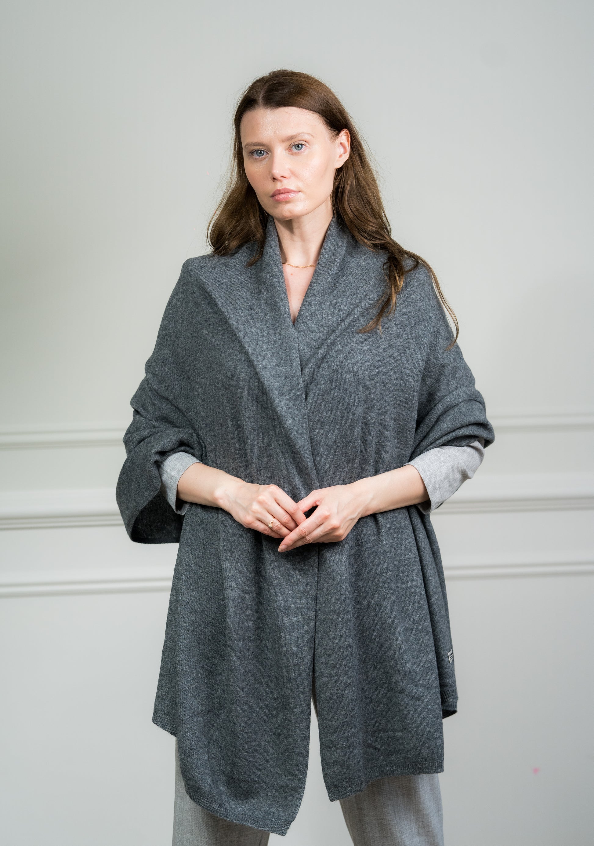 Close-up of the Charcoal Travel Wrap on a model, highlighting the soft cashmere texture and fine knit quality.