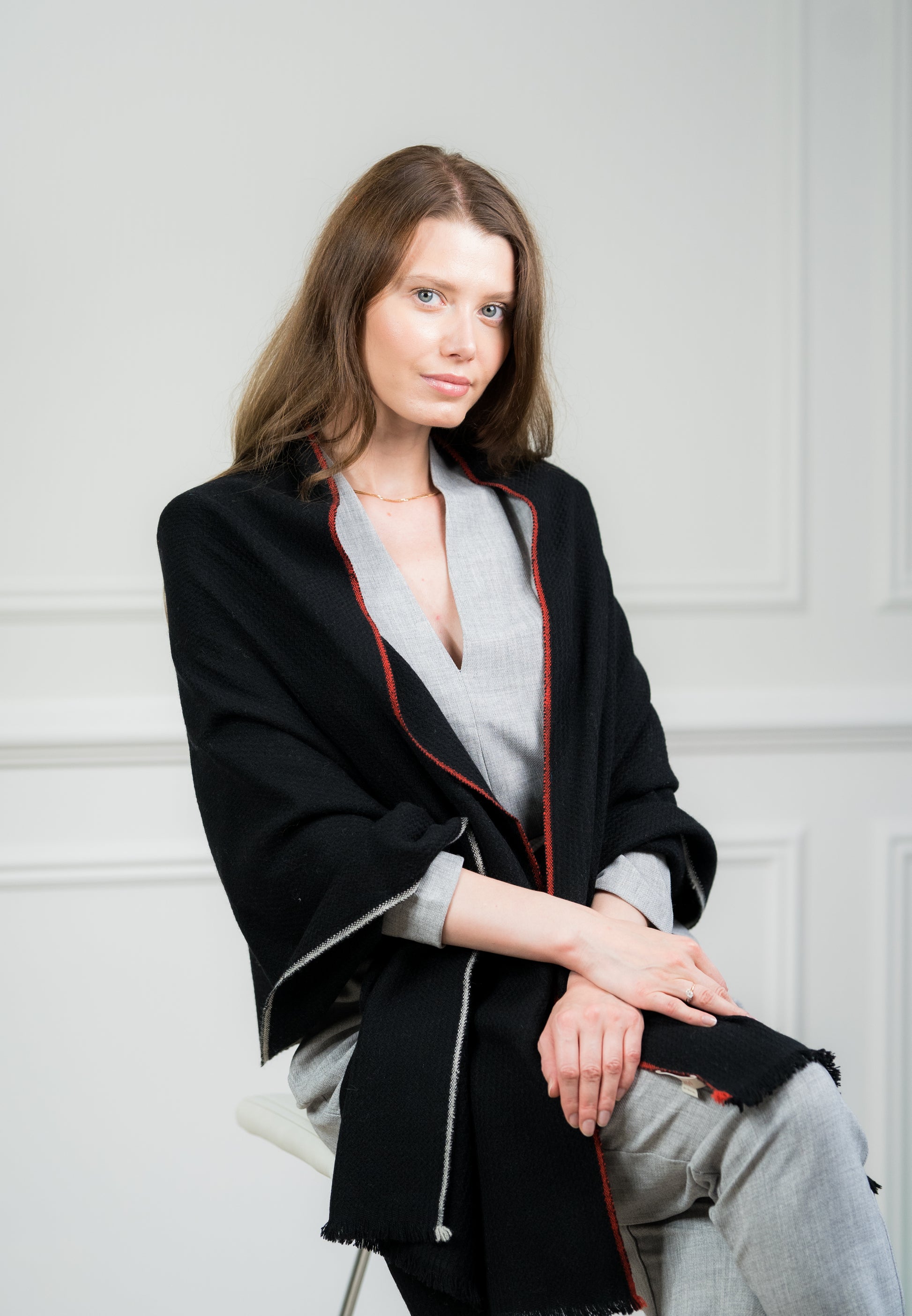 Model draping the Zigzag with Border Shawl over shoulders, illustrating its versatility as a women's scarf and travel wrap, making it a thoughtful gift for any occasion.