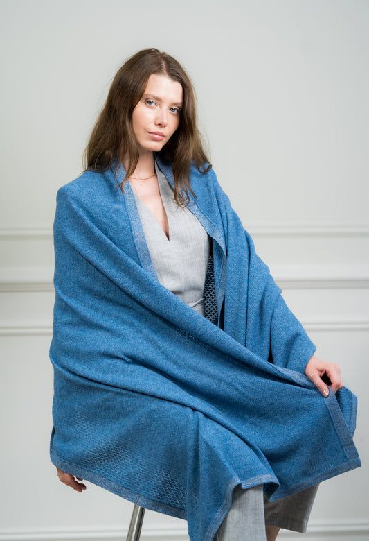 Model wearing Caprus Cashmere's pure cashmere Sky Pointelle Wrap, showcasing its intricate pointelle pattern and soft texture.