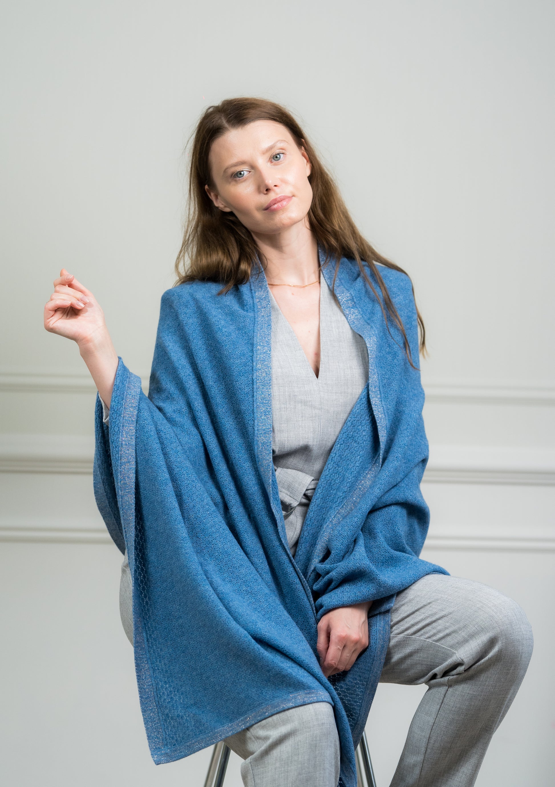 Close-up of the Sky Pointelle Wrap on a model, highlighting the fine cashmere knit and delicate pointelle detailing.