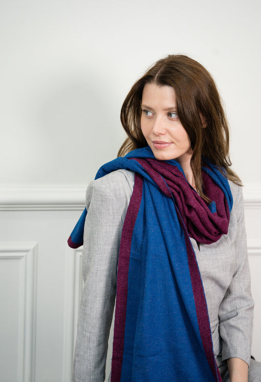 Model wearing Caprus Cashmere's pure cashmere Blue Wine Two Tone Scarf, showcasing the elegant blend of blue and wine hues.