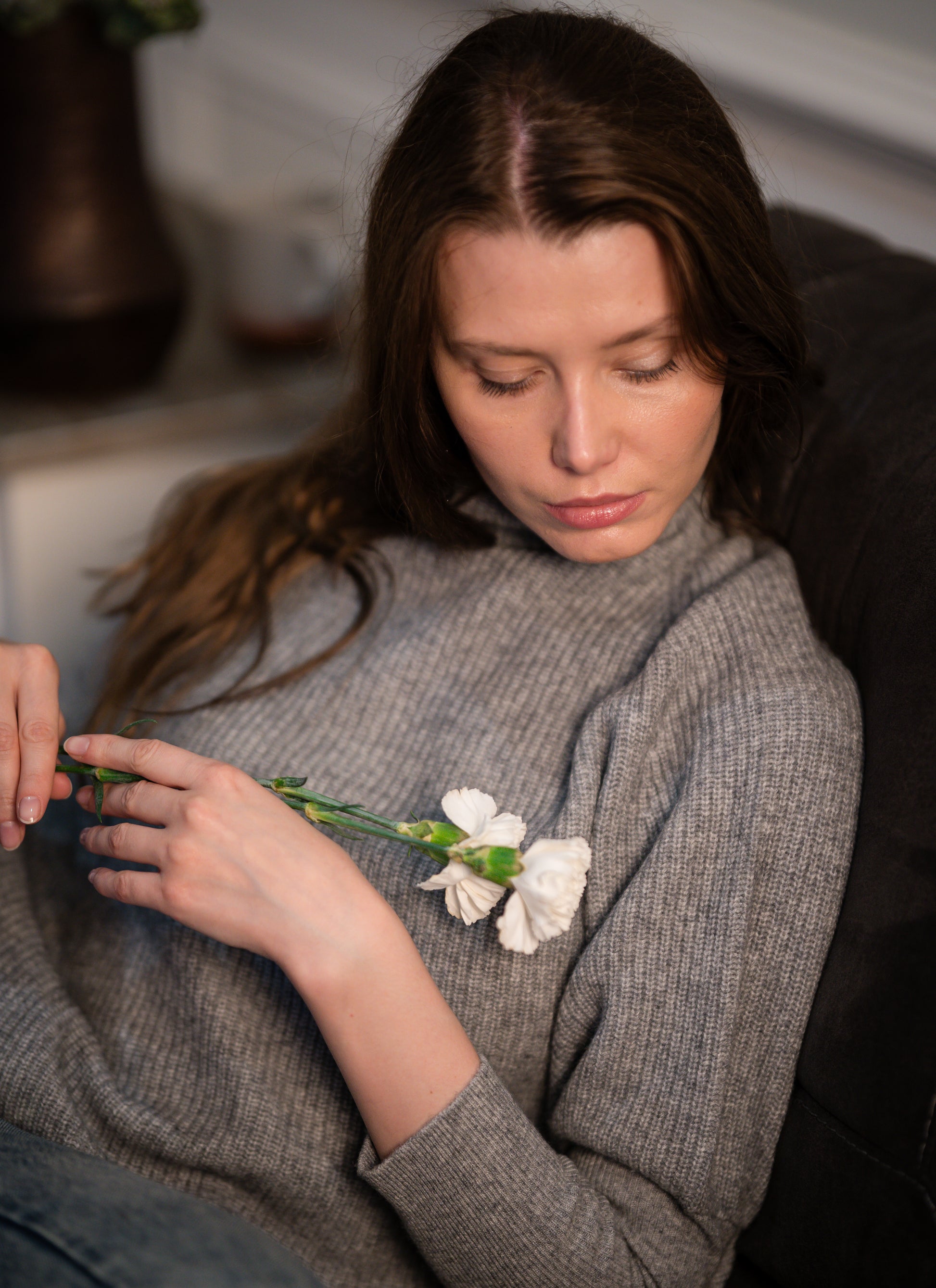 Side view of the Ribbed High Neck Sweater worn by a model, emphasizing its relaxed fit and high neckline.