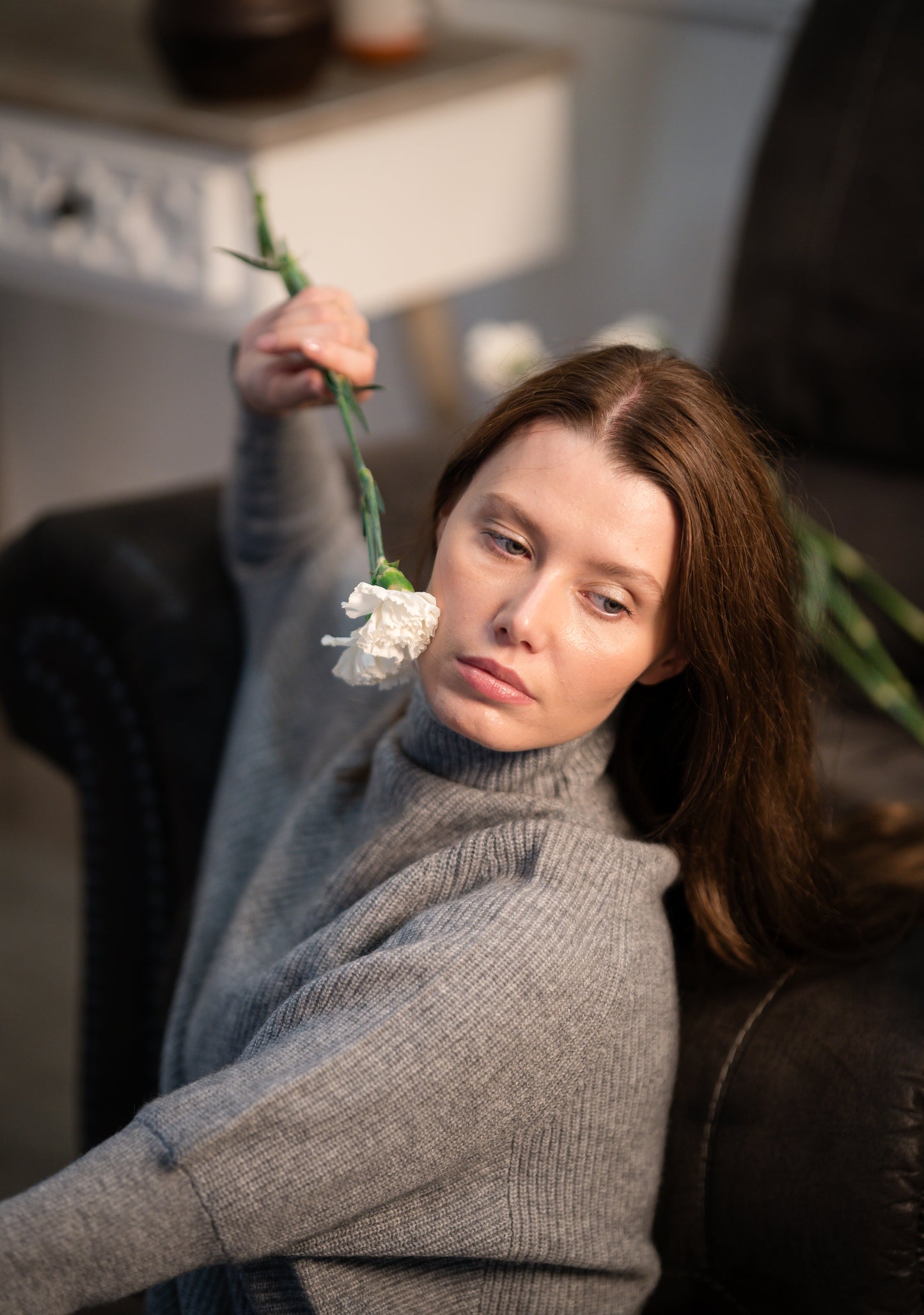 Close-up of the Ribbed High Neck Sweater on a model, highlighting the fine ribbed pattern and soft cashmere material.