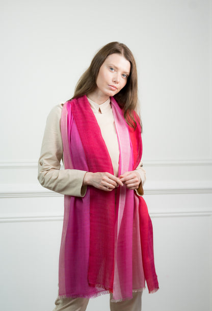 Model wearing Caprus Cashmere's pure cashmere Herringbone Rosy Four Color Block Scarf, featuring rosy pink, gray, beige, and white blocks.