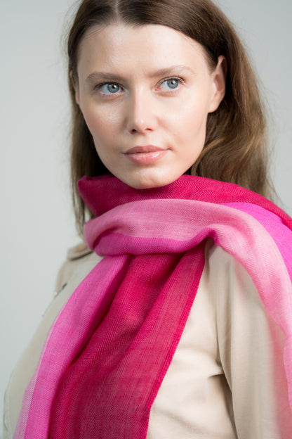Side profile of a model wearing the Herringbone Rosy Four Color Block Scarf, illustrating its elegant design and vibrant rosy pink color block.