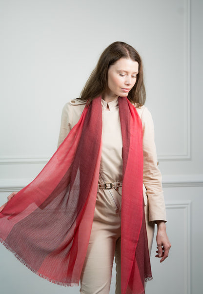 Model wearing Caprus Cashmere's pure cashmere Herringbone Ruby Four Color Block Scarf, featuring ruby red, gray, beige, and white blocks.