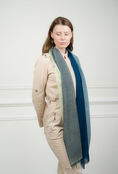 Model wearing Caprus Cashmere's pure wool 4 Color Block Jade Scarf, featuring vibrant jade green, gray, beige, and white blocks.