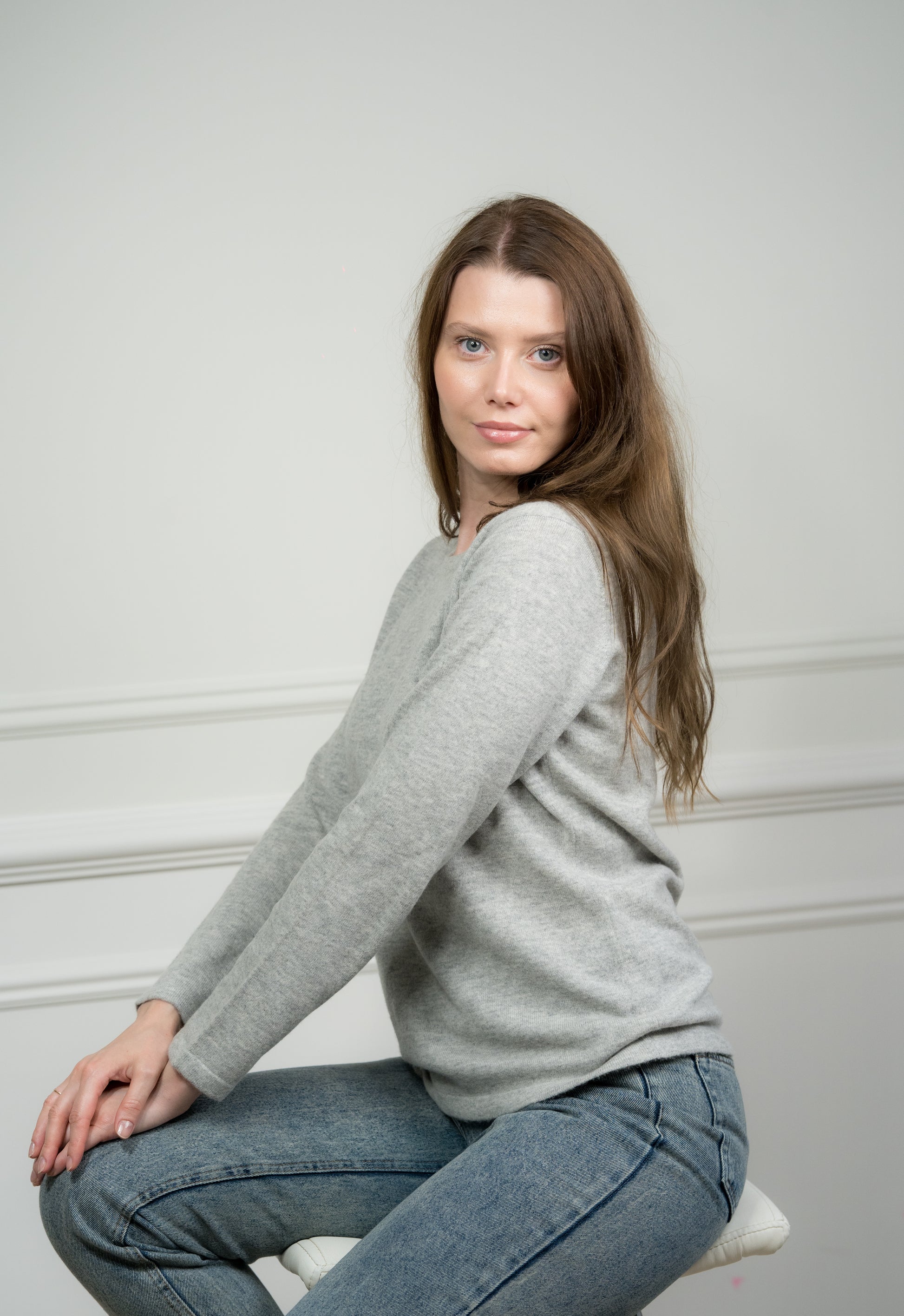 Back view of the light grey crew neck jumper on a model, displaying the seamless construction and quality craftsmanship.