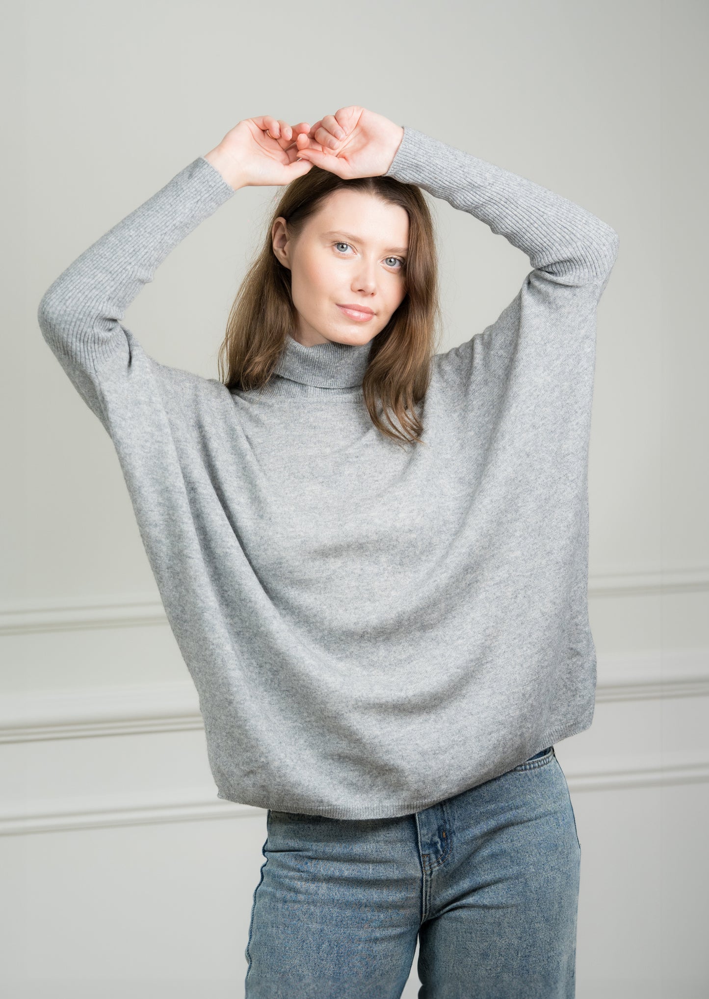 Close-up of the Grey Boxy Sweater on a model, highlighting the soft cashmere texture and ribbed detailing on the cuffs and hem.