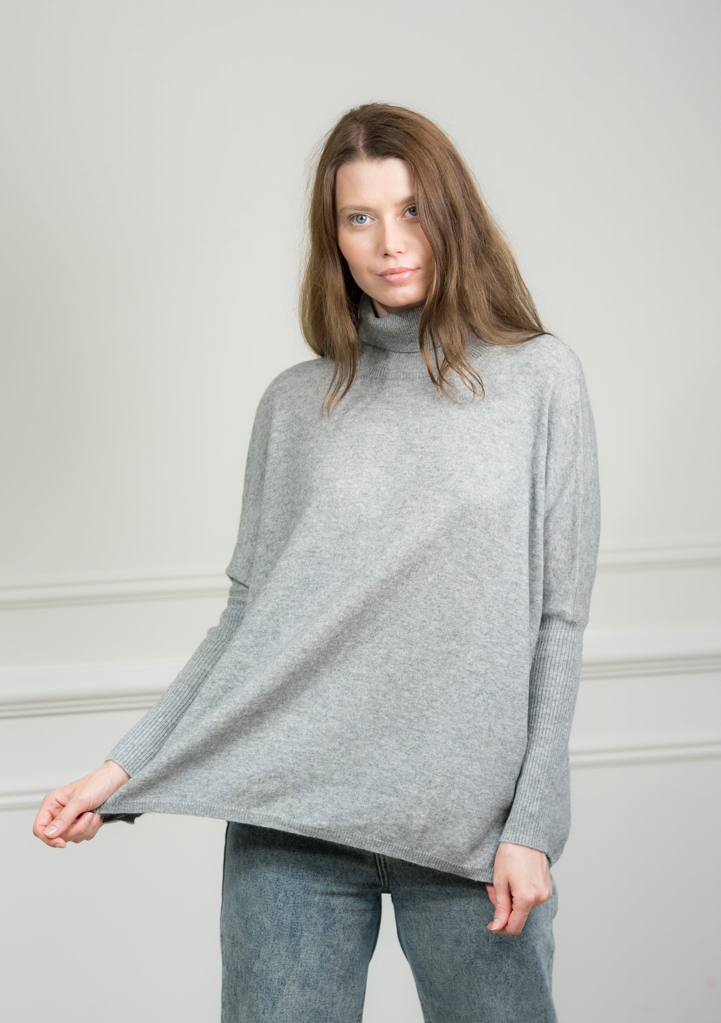 Model wearing Caprus Cashmere's pure cashmere Grey Boxy Sweater, showcasing its relaxed fit and versatile grey hue.