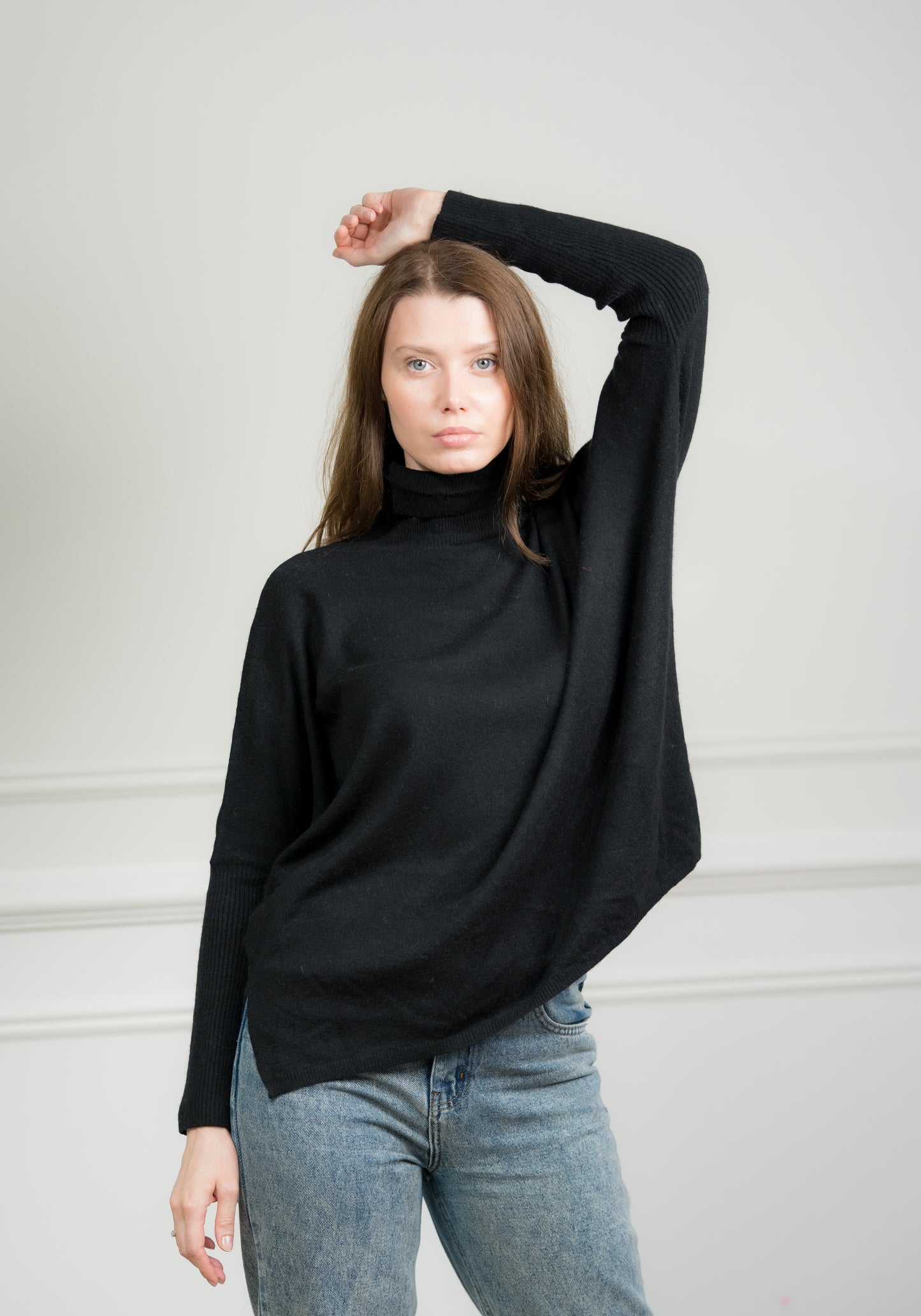 Model pairing the Black Boxy Sweater with jeans, illustrating its versatile style suitable for both casual and formal occasions.