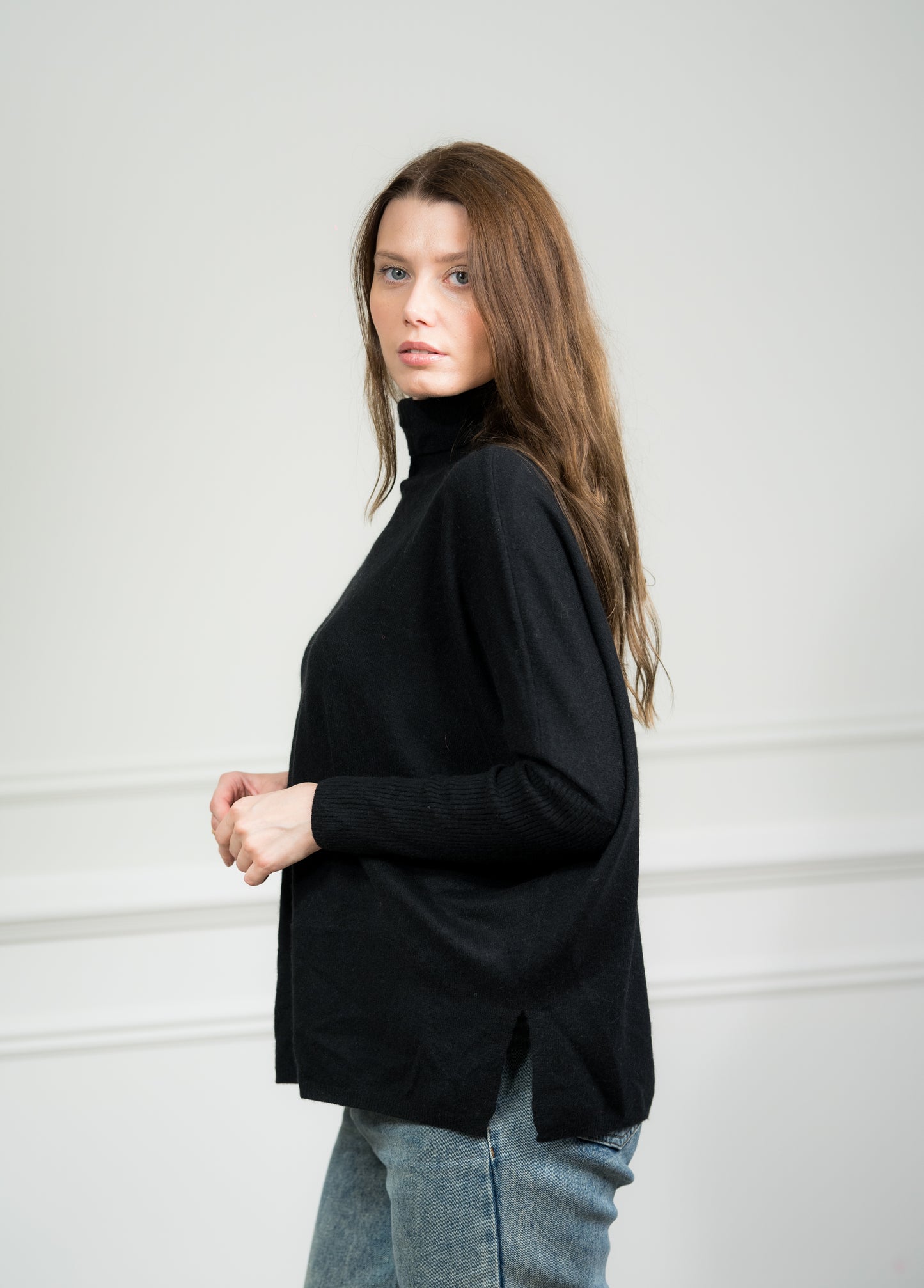 Close-up of the Black Boxy Sweater on a model, highlighting the soft cashmere texture and ribbed detailing on the cuffs and hem.