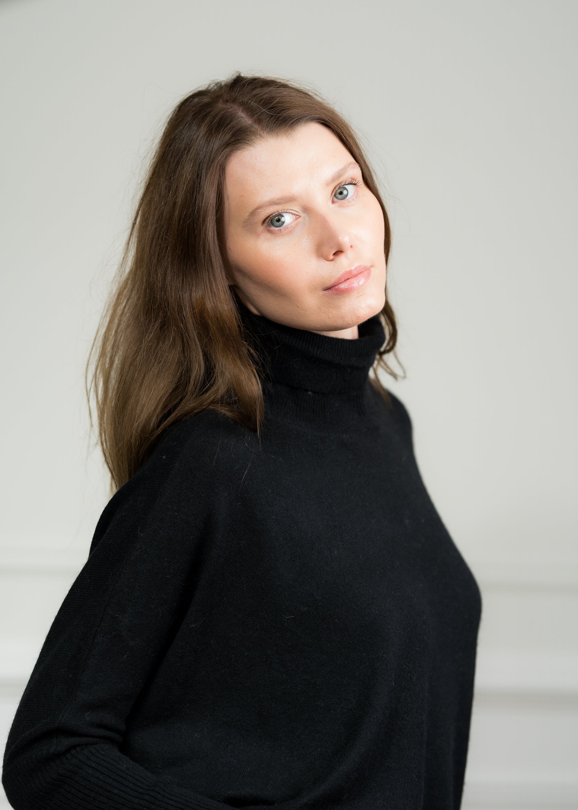 Side view of the Black Boxy Sweater worn by a model, emphasizing its loose silhouette and dropped shoulder design.