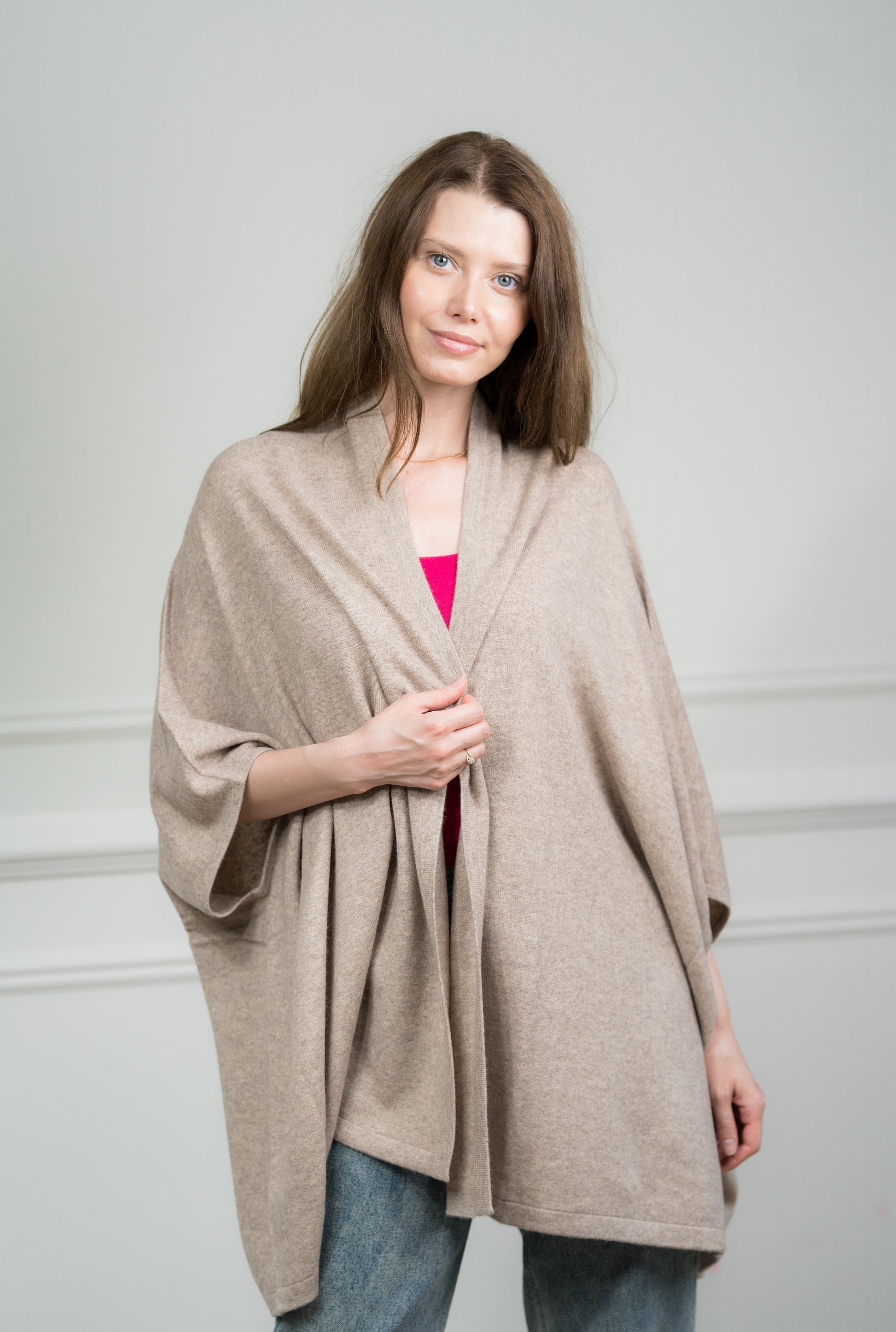 Model wearing Caprus Cashmere's pure cashmere Taupe Kimono, showcasing its elegant drape and neutral taupe color, perfect for layering over various outfits.