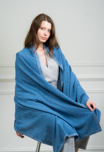 Model wearing Caprus Cashmere's pure cashmere Sky Pointelle Wrap, showcasing its intricate pointelle pattern and soft texture.