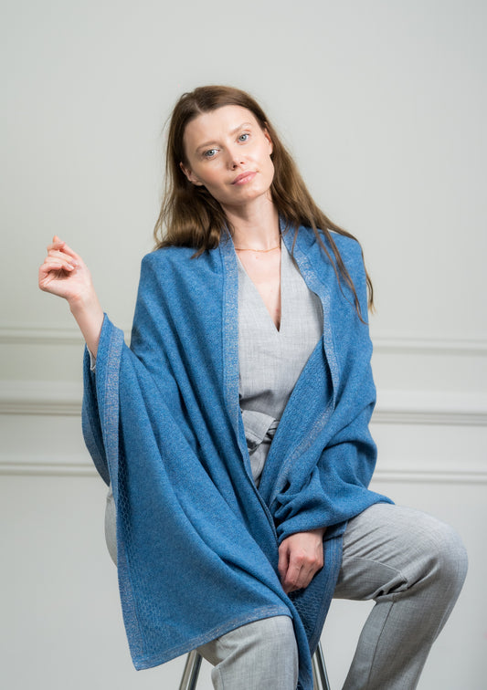 Close-up of the Sky Pointelle Wrap on a model, highlighting the fine cashmere knit and delicate pointelle detailing.